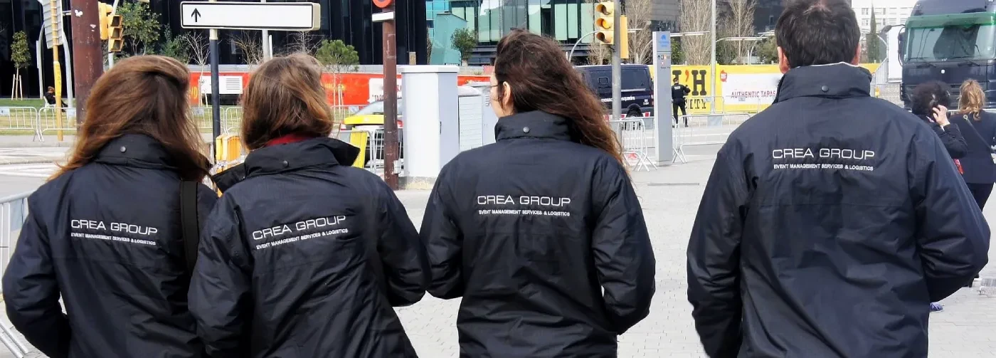 Back view of CREA Group logistics staff wearing branded black jackets.