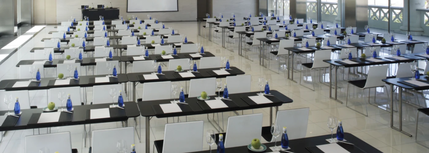 Modern conference room setup with blue water bottles and green apples for business meetings