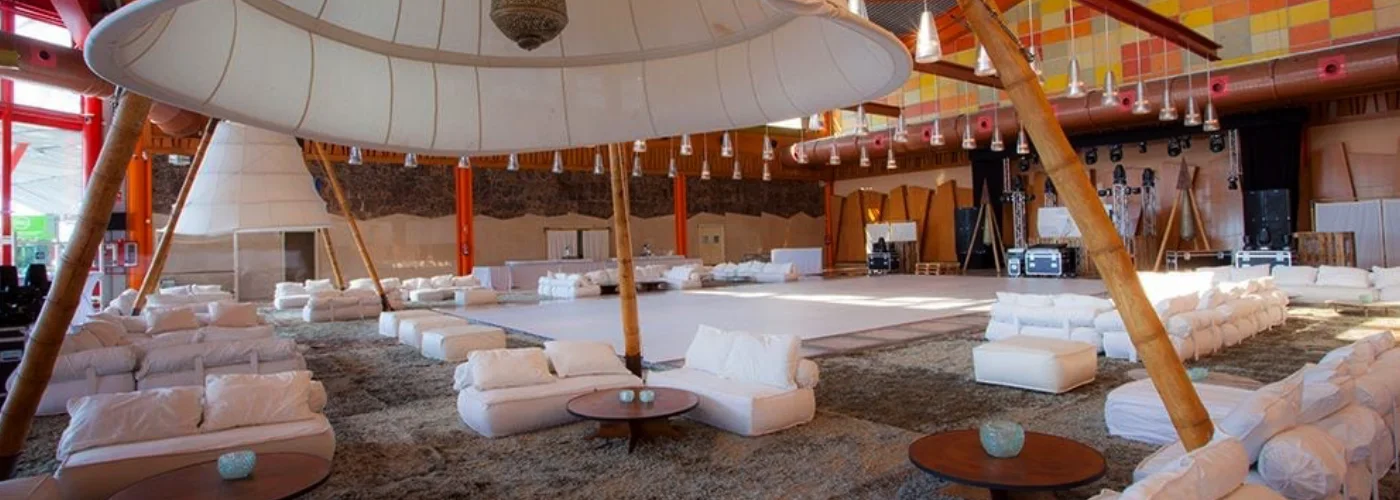 Unique luxury event space with giant white canopy bamboo structure and white lounge seating