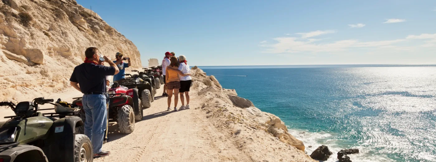 Group of employees on a guided quad bike tour along the Mediterranean coast.