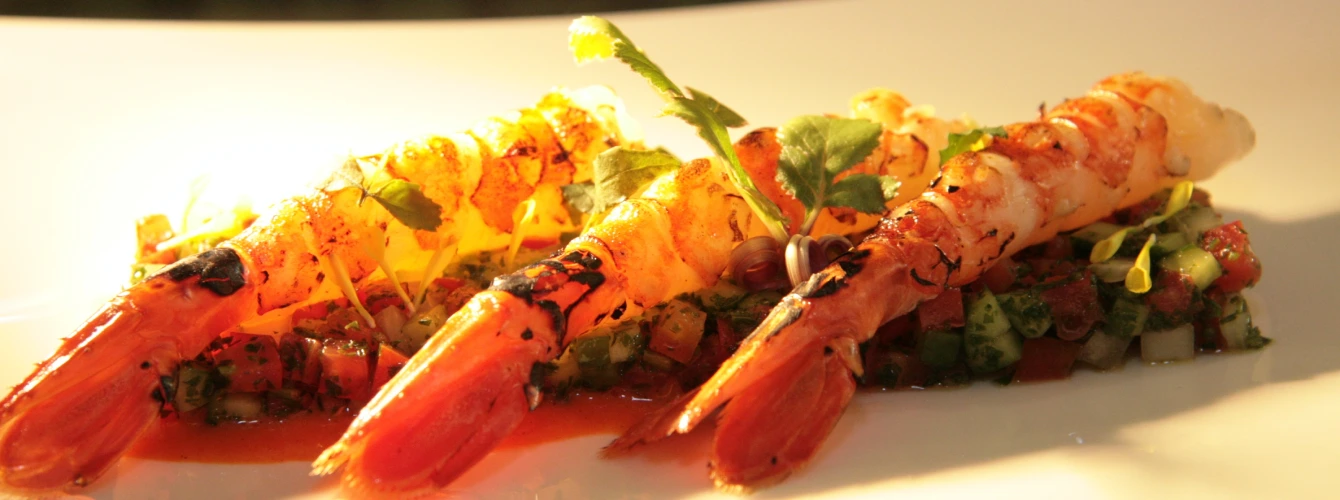High-end Mediterranean seafood dish served during a business dinner in Spain.