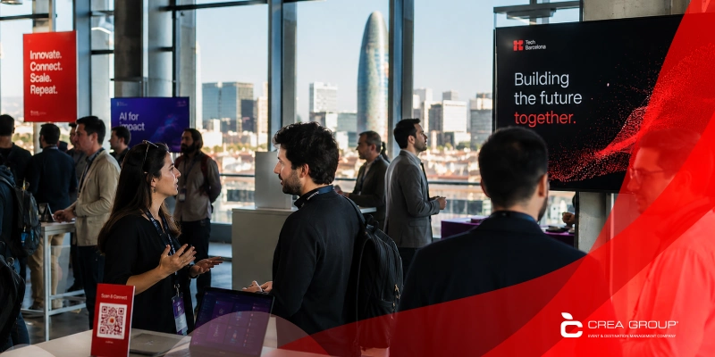 Business professionals networking at Tech Barcelona conference with Torre Glòries skyline view and Crea Group logo.