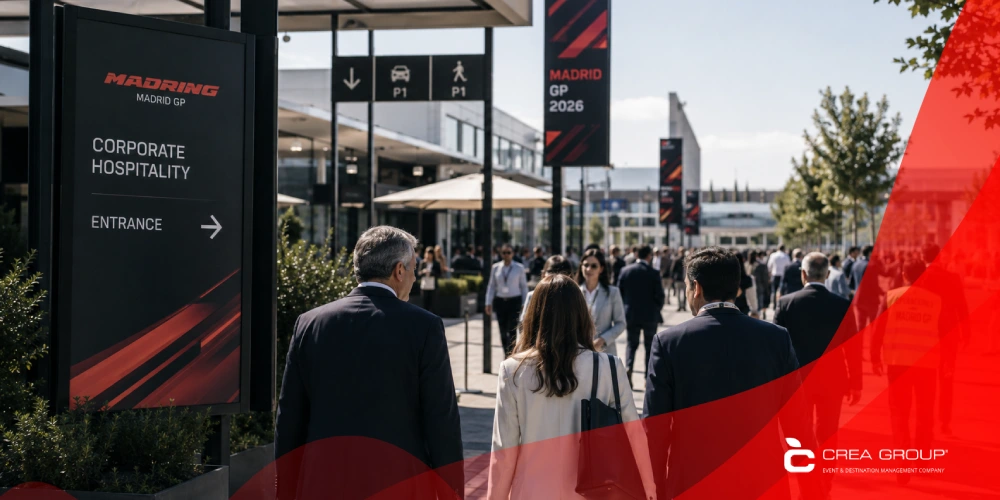 Business professionals walking towards the corporate hospitality entrance at the Madrid GP 2026 event venue during daytime.