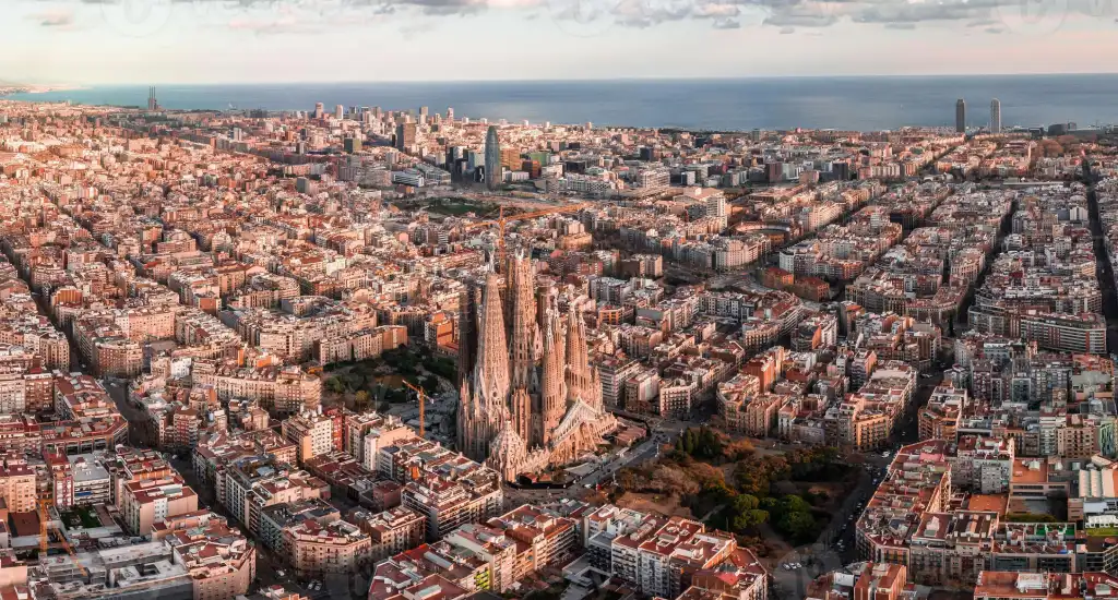 Barcelona skyline at sunset with professionals networking outdoors during a corporate event organized by CREA Group Events