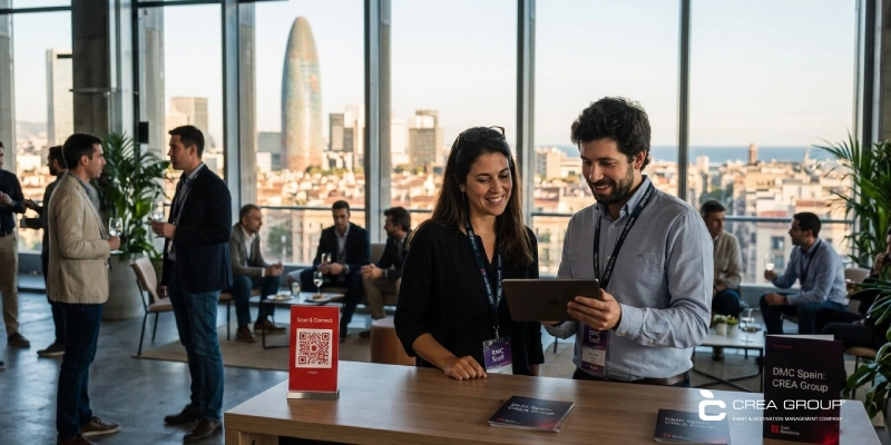 tech-barcelona-event-registration-scan-and-connect Event staff assisting an attendee at the Tech Barcelona registration desk with Torre Glòries skyline view.