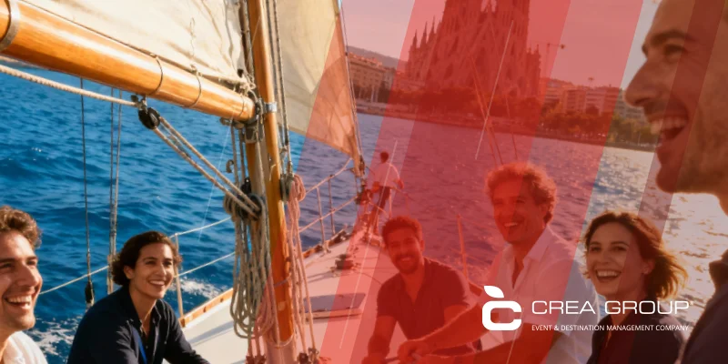 Diverse corporate team enjoying sailing regatta team building activity in Barcelona harbor with Sagrada Familia view and Crea Group Events